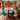 The dining room boasts a warm and inviting atmosphere, enhanced by an oriental-style carpet measuring 5x8. The round dining table, situated at the centre of the
