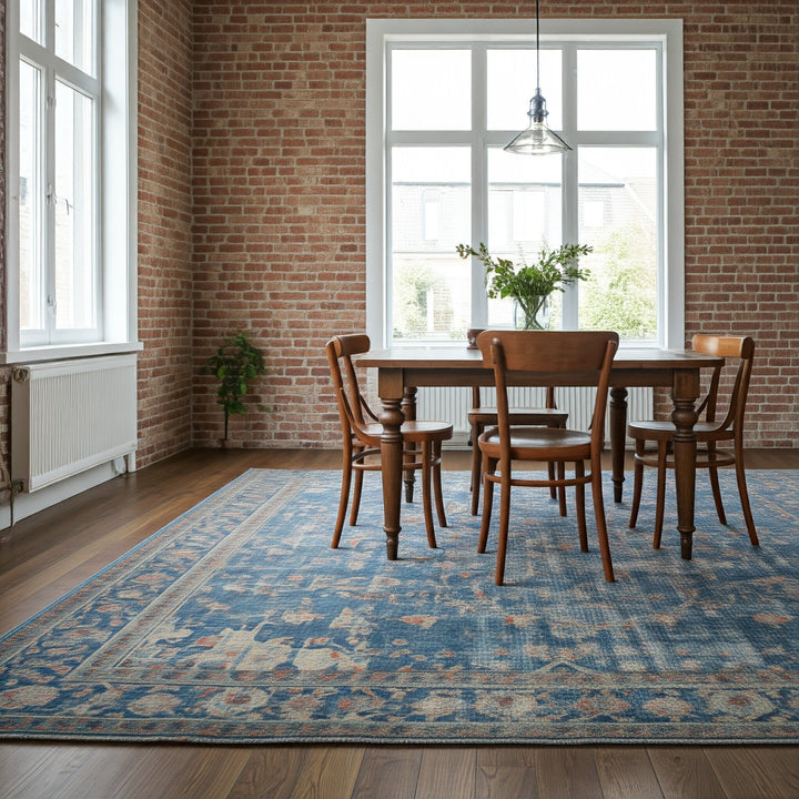 A modern, minimalist dining room with a rustic touch. The rectangular wooden dining table is surrounded by four matching wooden chairs, all set on a large, intr