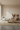Beige vintage Turkish area rug 6x10 feet in organic modern living room with travertine table